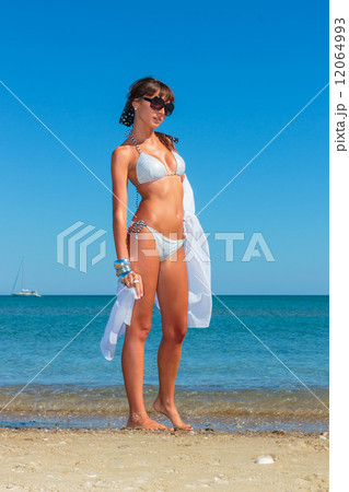 Young woman with pareo on the beach 12064993