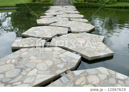 stone walkway on water in the park 12067629