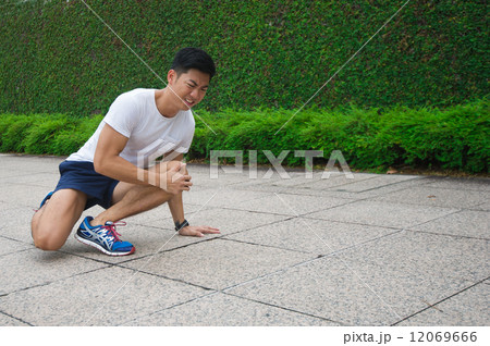 Young Asian male injuried during exercising 12069666