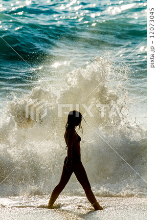 Beautiful Woman in Bikini Standing in the Sea Waves and Enjoying 12073045