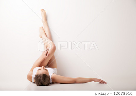 Beautiful woman legs raised up high lying 12078916