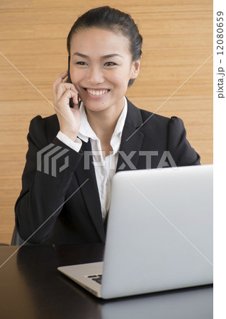 Asian Business Woman indoor with laptop computer 12080659