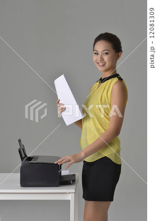 Asian Office Lady printing out documnet Asian Office Lady printing out documnet 12081309