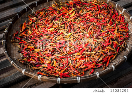 Dry red hot chili peppers wicker basket at asian market 12083292