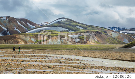Blurred Tourists walking across Landmannalaugar unbelievable landscape, Iceland 12086326
