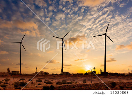 Wind generator turbines sihouettes on sunset 12089863