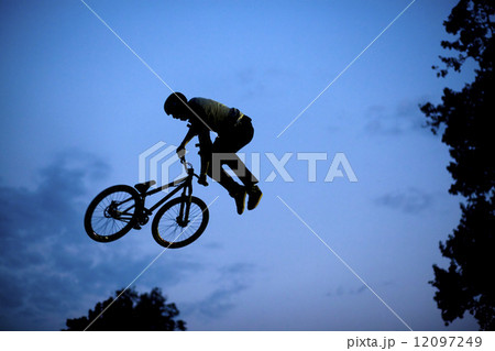 Silhouette of a man doing a jump with a bmx bike 12097249