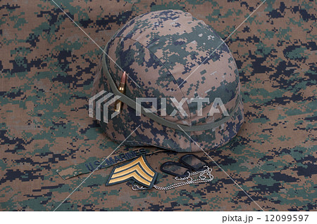 kevlar helmet with dog tags and cartridges on camouflage cover kevlar helmet with dog tags and cartridges on camouflage cover 12099597