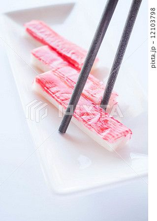 Crab sticks group and wood chopsticks on white plate 12103798