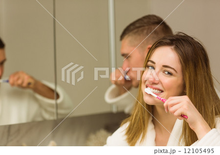 Cute couple brushing their teeth Cute couple brushing their teeth 12105495