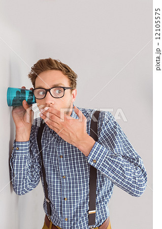 Geeky businessman eavesdropping with cup Geeky businessman eavesdropping with cup 12105575