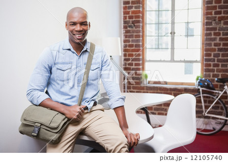 Casual businessman smiling at camera Casual businessman smiling at camera 12105740