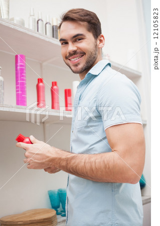 Smiling hairdresser with hair products Smiling hairdresser with hair products 12105823
