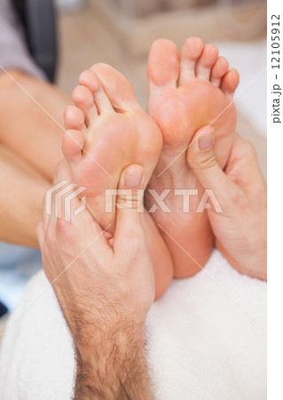 Customers getting both feet massaged Customers getting both feet massaged 12105912