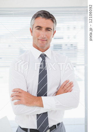 Serious businessman with folded arms Serious businessman with folded arms 12106092