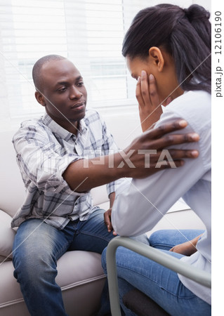Worried woman being comforted by her therapist Worried woman being comforted by her therapist 12106190