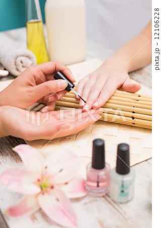 Nail technician giving customer a manicure Nail technician giving customer a manicure 12106228