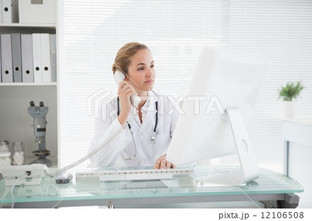 Doctor taking a phone call Doctor taking a phone call 12106508