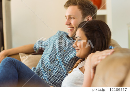 Happy young couple relaxing on the couch 12106557