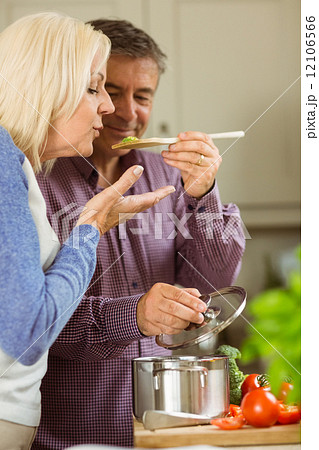 Mature couple preparing meal together 12106566