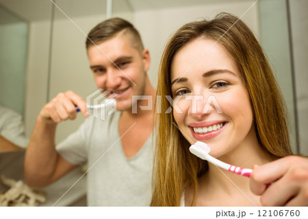 Cute couple brushing their teeth 12106760