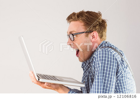 Geeky businessman using his laptop 12106816