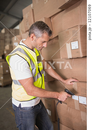 Worker scanning package in warehouse Worker scanning package in warehouse 12107069