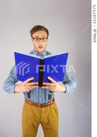 Geeky businessman reading a book 12107575