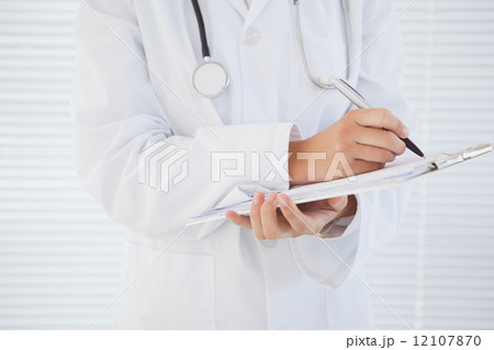 Doctor writing down some notes 12107870