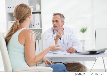 Concerned doctor talking to his patient 12107872