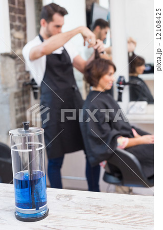 Handsome hair stylist with client 12108425