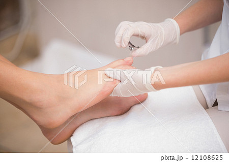 Woman getting a pedicure from beautician 12108625