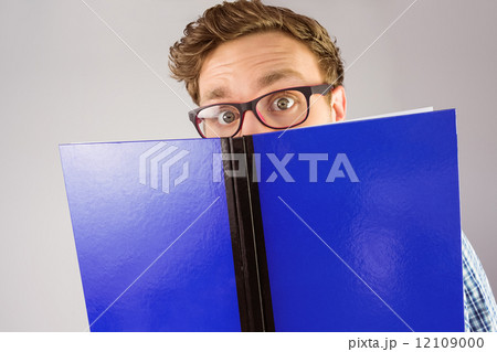 Geeky student reading a book Geeky student reading a book 12109000