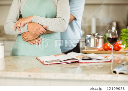 Mature couple preparing vegetarian meal together 12109028