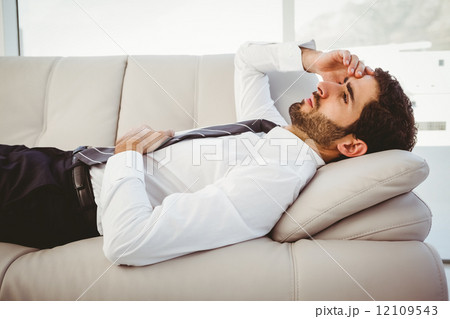 Sick businessman lying on the couch 12109543