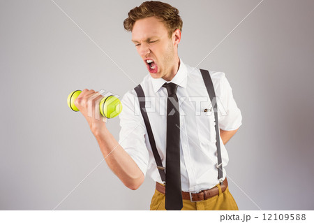 Geeky businessman lifting a dumbbell 12109588