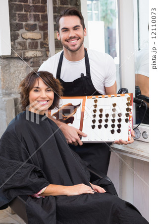 Pretty brunette picking out hair colour with stylist Pretty brunette picking out hair colour with stylist 12110073
