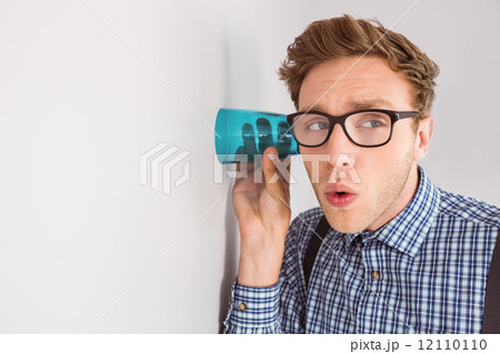 Geeky businessman eavesdropping with cup 12110110