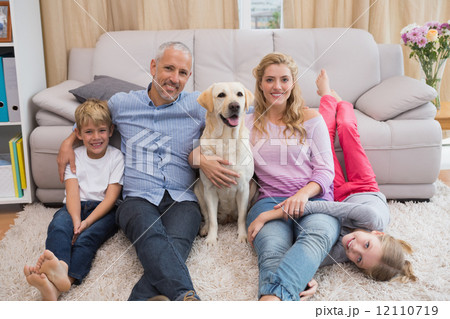 Parents and children on rug with labrador Parents and children on rug with labrador 12110719