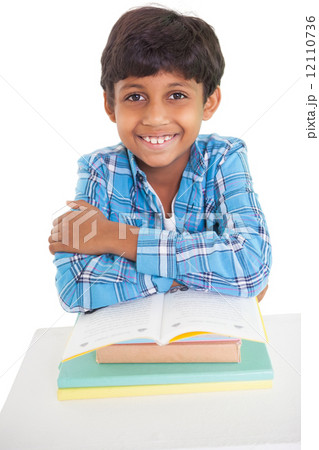 Cute elementary pupil smiling at camera 12110736