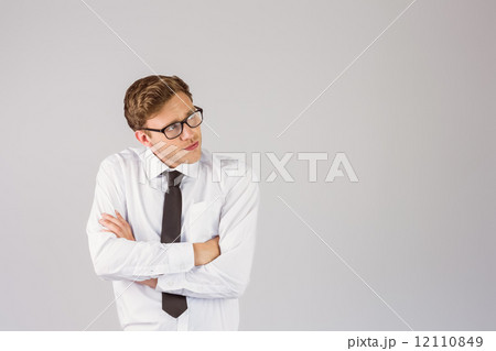 Young businessman thinking with arms crossed 12110849
