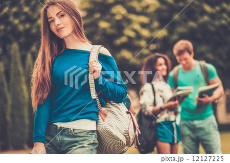Beautiful young girl student in a city park on summer day 12127225