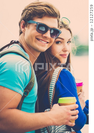 Couple tourists with map and coffee cups near river in a city 12127259