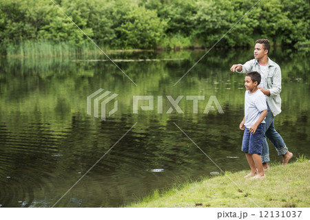 Two brothers playing by a lake. Two brothers playing by a lake. 12131037