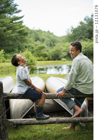 Two brothers playing by a lake. 12131076
