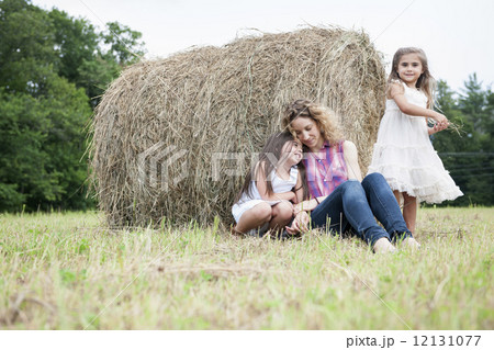 Mother playing outdoors with her daughters. 12131077