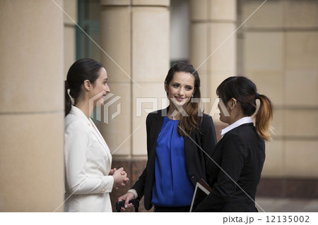 Three Businesswomen outdoors talking. Three Businesswomen outdoors talking. 12135002