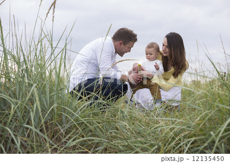 Young family In Sand Dunes. Young family In Sand Dunes. 12135450