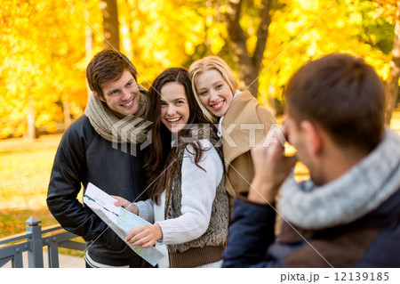 group of friends with map outdoors group of friends with map outdoors 12139185