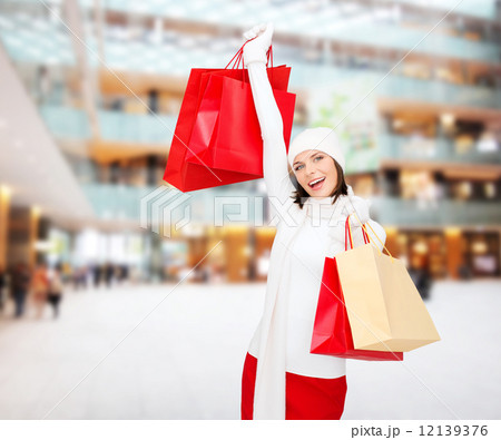 smiling young woman with red shopping bags smiling young woman with red shopping bags 12139376